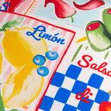 Close-up of the Mediterranean Picnic Abstract Polyester Cushion, showing hand-painted lemons, blueberries and olives with "Limón" text on pink stripes and blue gingham panels.