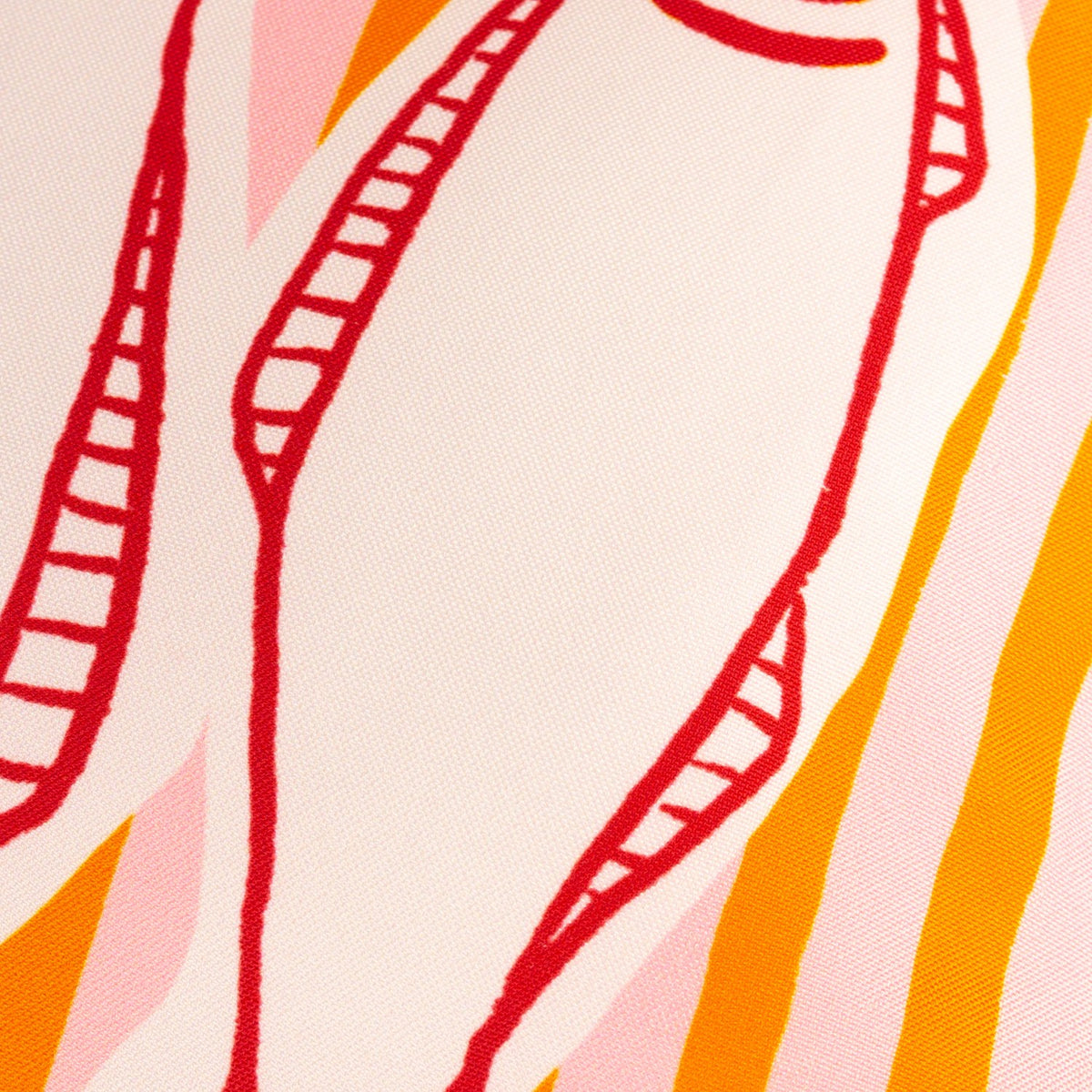Close-up of the Mediterranean Sardines Reversible Polyester Cushion showing red line-drawn fish detail on a pink-and-orange striped fabric background.