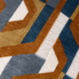 Close-up of the Metro Prism Jacquard Velvet Cushion in Ginger, showing an interlocking geometric maze pattern in ginger, teal blue, slate grey and cream velvet.