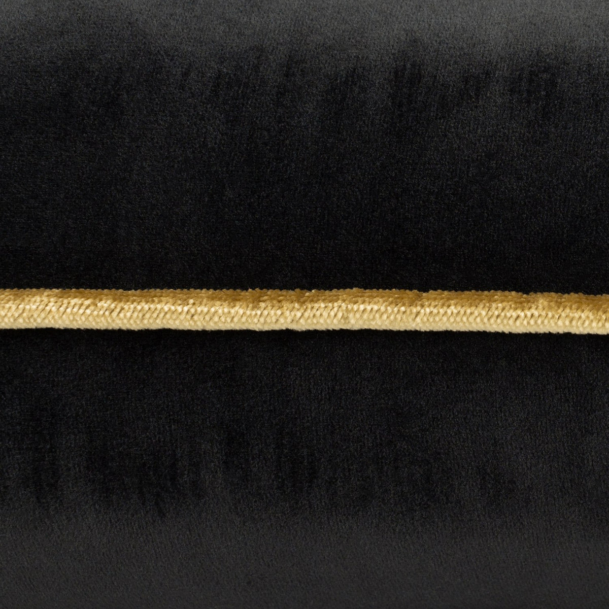 Close-up of the Meridian Plain Velvet Cushion in black, showing the velvet texture with a contrasting gold piped border trim.