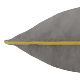 Close-up of the Meridian Plain Velvet Cushion in charcoal grey with a contrasting yellow piped edge, shown against a plain white background.