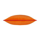 Meridian Plain Velvet Cushion in clementine orange with a contrasting hot pink piped edge, shown lengthways on a plain white background.