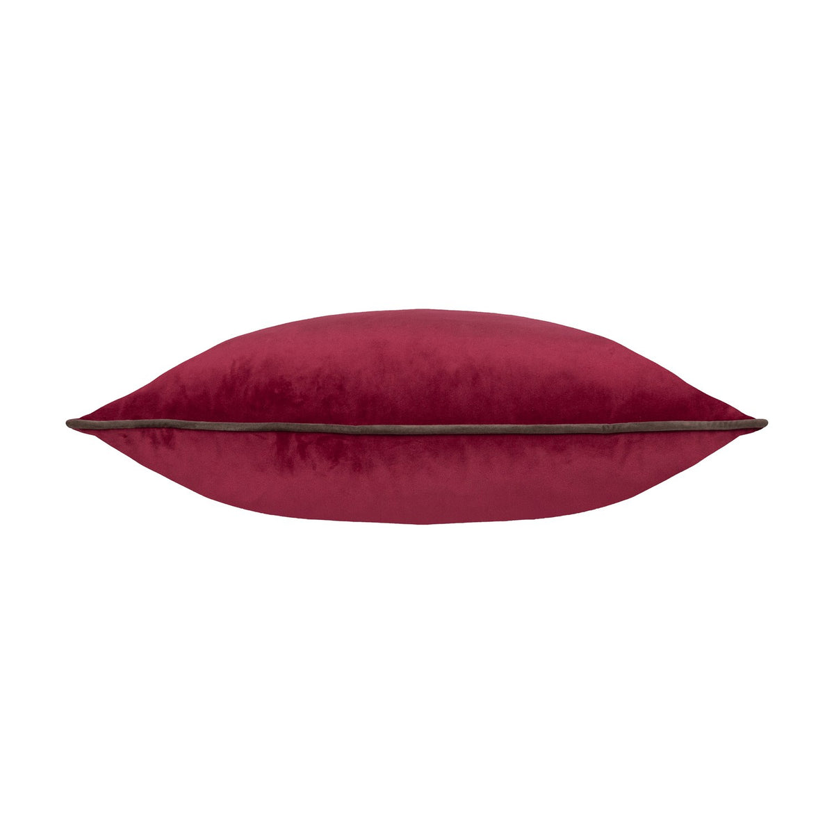 Side view of the Meridian Plain Velvet Cushion in cranberry pink velvet with a contrasting mocha brown piped edge, shown plump and full on a plain white background.