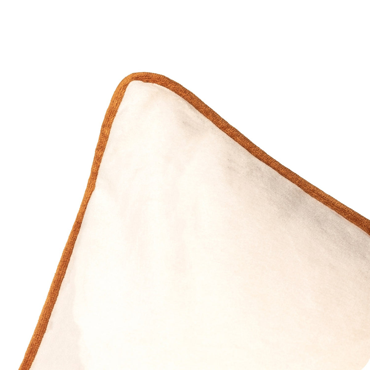 Close-up of the Meridian Plain Velvet Cushion in ecru, showing the corner with contrasting ginger piped edge, on a plain white background.
