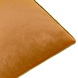 Close-up of the Meridian plain velvet cushion in ginger with an olive piped trim edge, shown on a plain white background.