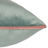 Close-up of the Meridian Plain Velvet Cushion in mineral blue velvet with a contrasting blush pink piped edge, shown on a plain white background.