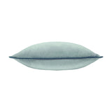 Meridian Plain Velvet Cushion in mineral blue, shown side-on to display its plump square shape with teal piped edging, on a plain white background.