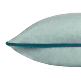 Close-up of the Meridian Plain Velvet Cushion in mineral blue, showing dense velvet texture and a teal piped edge trim against a plain white background.