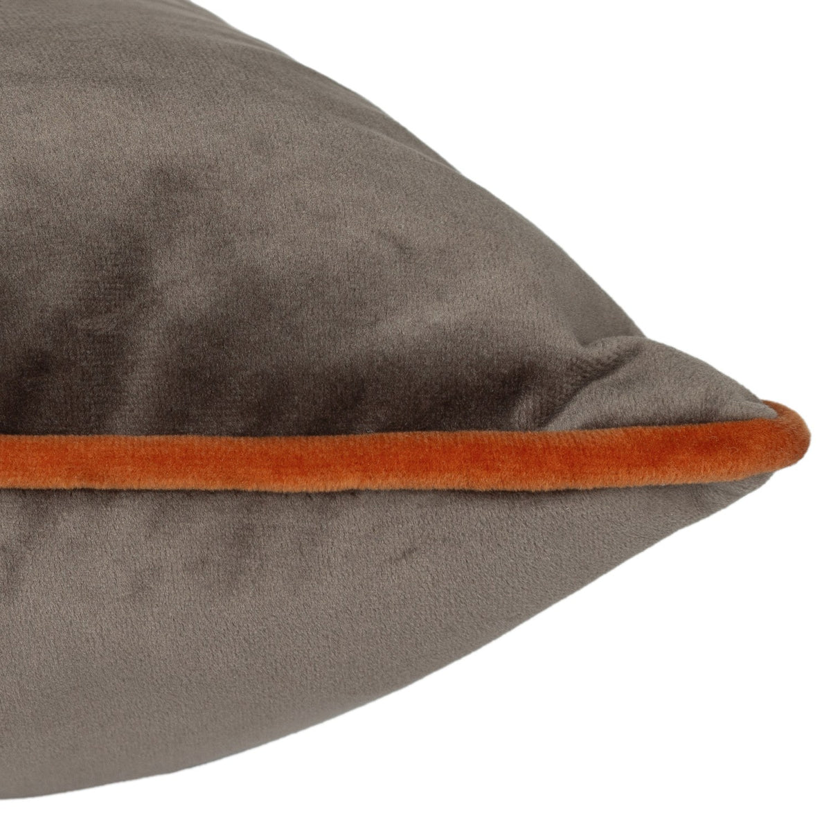 Close-up of the Meridian Plain Velvet Cushion in mocha brown, showing the corner detail with a contrasting pumpkin orange piped edge, on a plain white background.