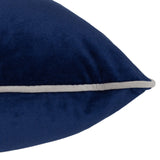 Close-up of the Meridian navy velvet cushion corner showing the plain front and silver-grey piped edge seam, on a plain white background.