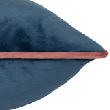 Close-up of the Meridian Plain Velvet Cushion in petrol blue, showing the soft velvet texture and blush pink piped edge along the seam.