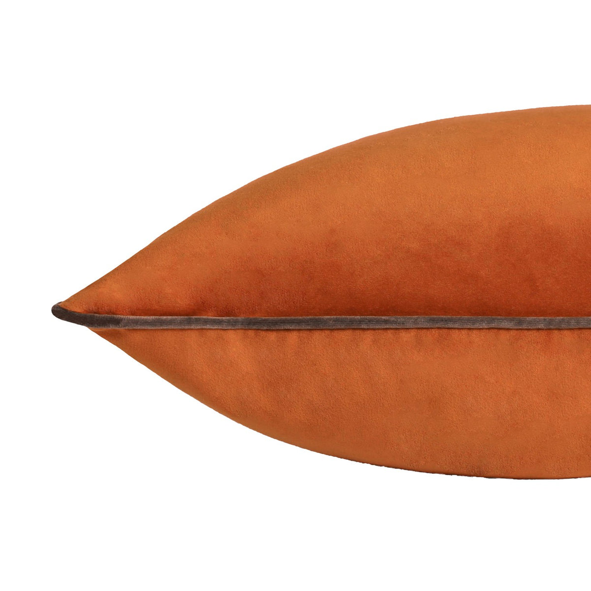 Close-up of the Meridian Plain Velvet Cushion in burnt pumpkin orange, showing the corner point and mocha brown piped edge detail on a white background.