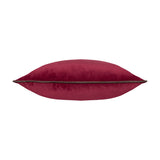 Meridian Plain Velvet Cushion in cranberry pink with a contrasting mocha piped edge, shown side-on against a plain white background.