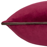 Close-up of the Meridian Plain Velvet Cushion in cranberry pink with a contrasting mocha brown piped edge, shown on a plain white background.
