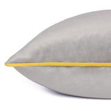 Close-up of the Meridian Plain Velvet Cushion in dove grey, showing the velvet-feel fabric edge with contrasting yellow piping, on a plain white background.