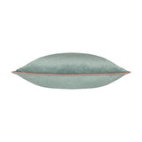 Meridian Plain Velvet Cushion in mineral blue with a blush pink piped edge seam, shown on its side against a plain white background.