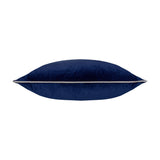 Meridian Plain Velvet Cushion in navy blue, shown side-on to reveal its plump square shape with a silver-grey piped edge, set against a plain white background.