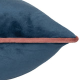 Close-up of the Meridian Plain Velvet Cushion in petrol blue, showing the soft velvet texture and contrasting blush pink piped edge on a white background.