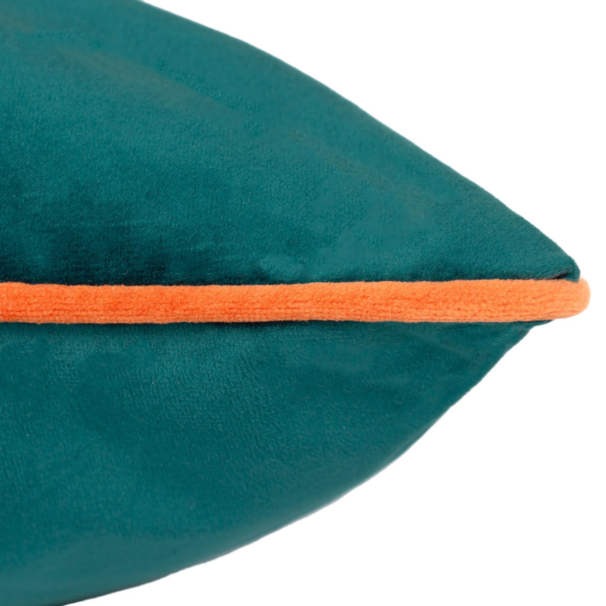Close-up of the Meridian Plain Velvet Cushion in teal, showing the corner with contrasting clementine orange piping, set against a plain white background.