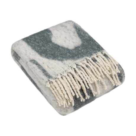 Meta Jacquard Polyester Throw in Dusk, folded to show a faux mohair finish with abstract grey-blue shapes on cream and fringed edges, on a white background.