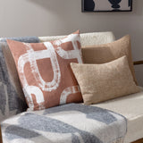 Meta Jacquard Polyester Throw in Dusk draped over a sofa arm, showing an abstract grey-blue pattern on a cream ground with soft faux mohair texture.