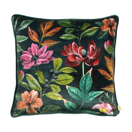 Square Midnight Garden velvet cushion in deep grey with a painterly floral print of pink and crimson blooms, coral flowers, green foliage and dark berries, shown on a plain white background.