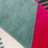 Close-up of the Metro Harlequin Jacquard Velvet Cushion, showing a geometric diamond pattern in green, pink, cream, orange and blue velvet with fine striped detailing.