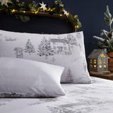 Midwinter Toile Printed Woodland Duvet Cover Set in Snow, with pillowcases featuring grey line-drawn cottages, fir trees and woodland motifs on white cotton.