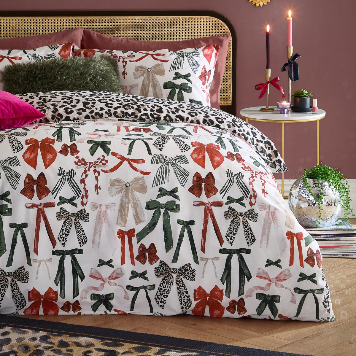 Mila Bows Reversible Animal Duvet Cover Set in Leopard, shown on a bed with bow-print cotton-polyester bedding and reverse leopard print, styled in a bedroom with cushions and candles.
