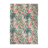Monkey Palm Jungle polyester rug in papyrus, featuring a repeating tropical print of palm trees, hanging pink fruit and small monkeys in green and pink tones, shown flat on a plain white background.