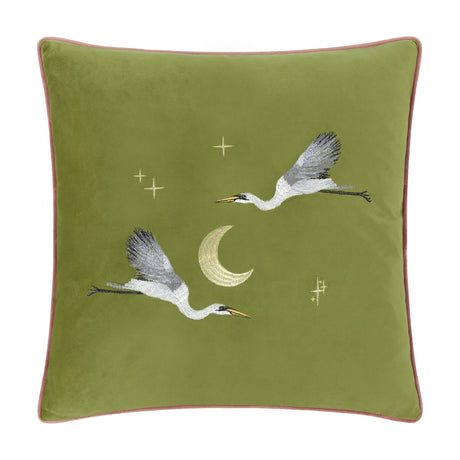 Moonlit Flight Animal Velvet Cushion in olive green, 45 x 45cm, with embroidered cranes in flight, a gold crescent moon and scattered stars, pink piped edge, shown on a plain white background.