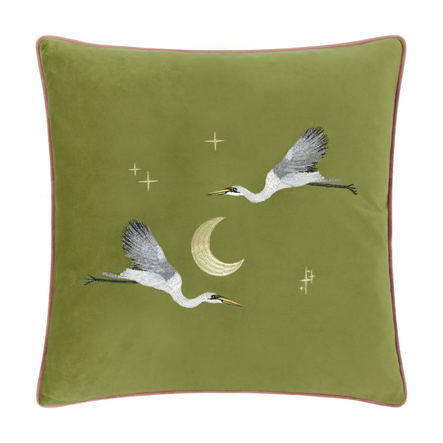 Moonlit Flight Animal Velvet Cushion in olive green, 45 x 45cm, with embroidered cranes in flight, a gold crescent moon and scattered stars, pink piped edge, shown on a plain white background.