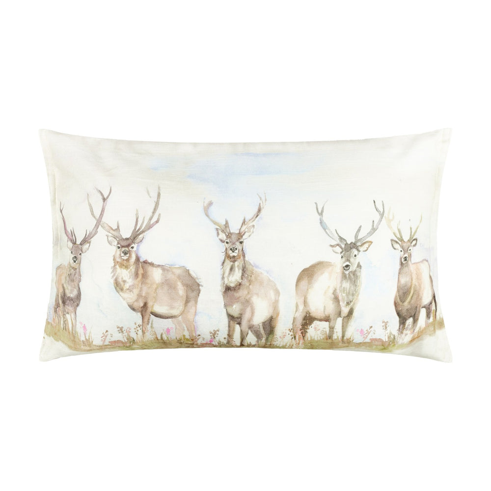 Moorland Stag Reversible Linen Cushion in Nut, rectangular, printed with watercolour stags in a meadow on cream fabric, shown on a plain white background.