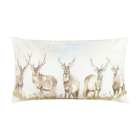 Moorland Stag Reversible Linen Cushion in Nut, rectangular, printed with watercolour stags in a meadow on cream fabric, shown on a plain white background.