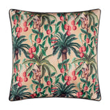 Square polyester cushion in Papyrus beige with a tropical print of palm trees, red lychee fruits and monkeys, finished with black piping, shown on a plain white background.