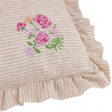 Martha Floral Linen Cushion in pink, close-up of oatmeal stripe fabric with corner floral embroidery in pink, coral and lilac, finished with a ruffled edge.