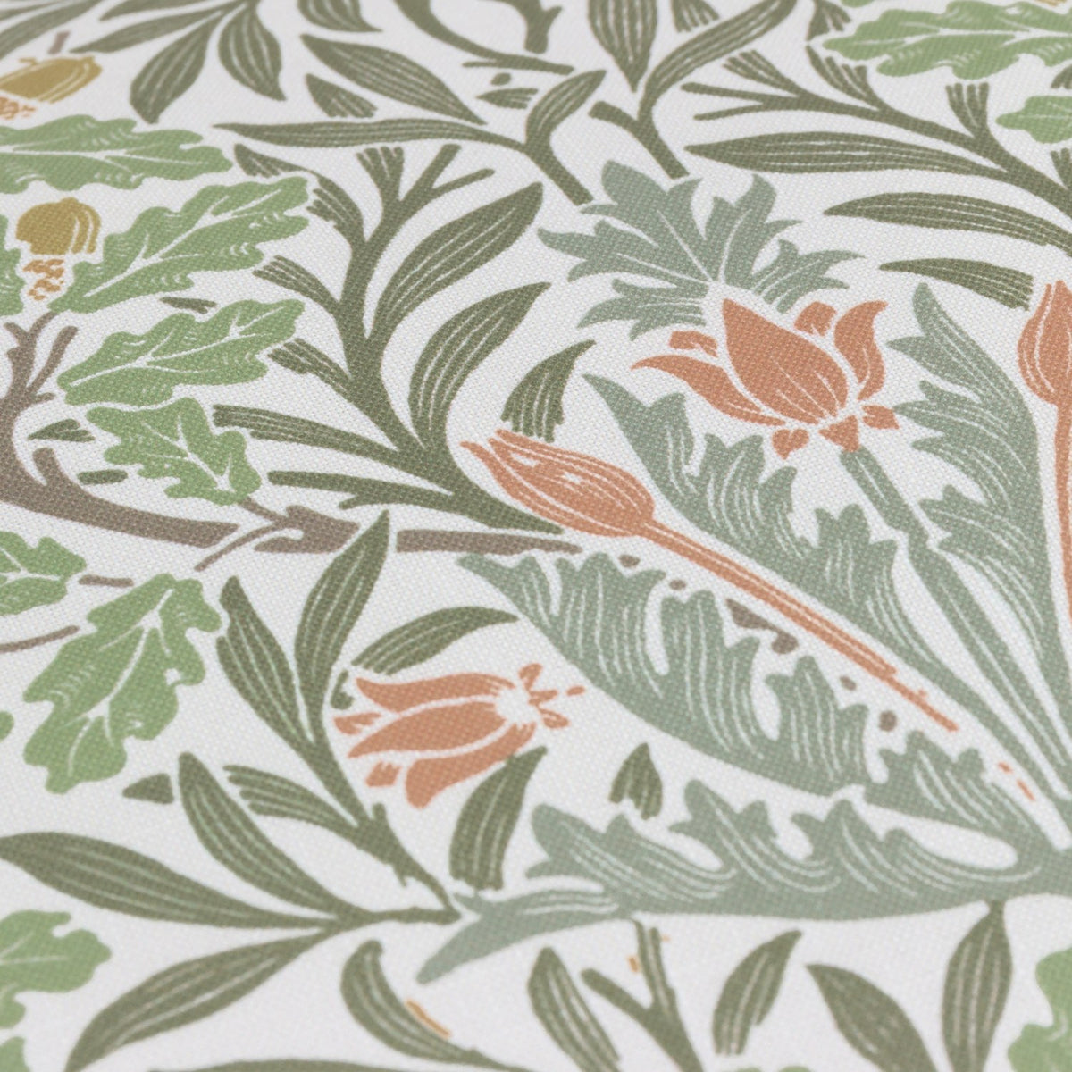 Close-up of the Multi Acorn Woodland polyester cushion fabric, showing oak leaves, acorns and terracotta flowers in sage, olive and stone tones on an off-white ground.