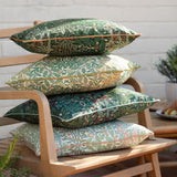Stack of four Multi Acorn Woodland polyester cushions in varied stone, sage, cream and dark green colourways with contrast piping, shown on a wooden garden bench.