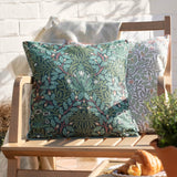 Multi Acorn Woodland square cushion in Thyme/Forest green with acorn and oak leaf print, shown on a wooden garden bench beside a matching lighter-toned cushion.