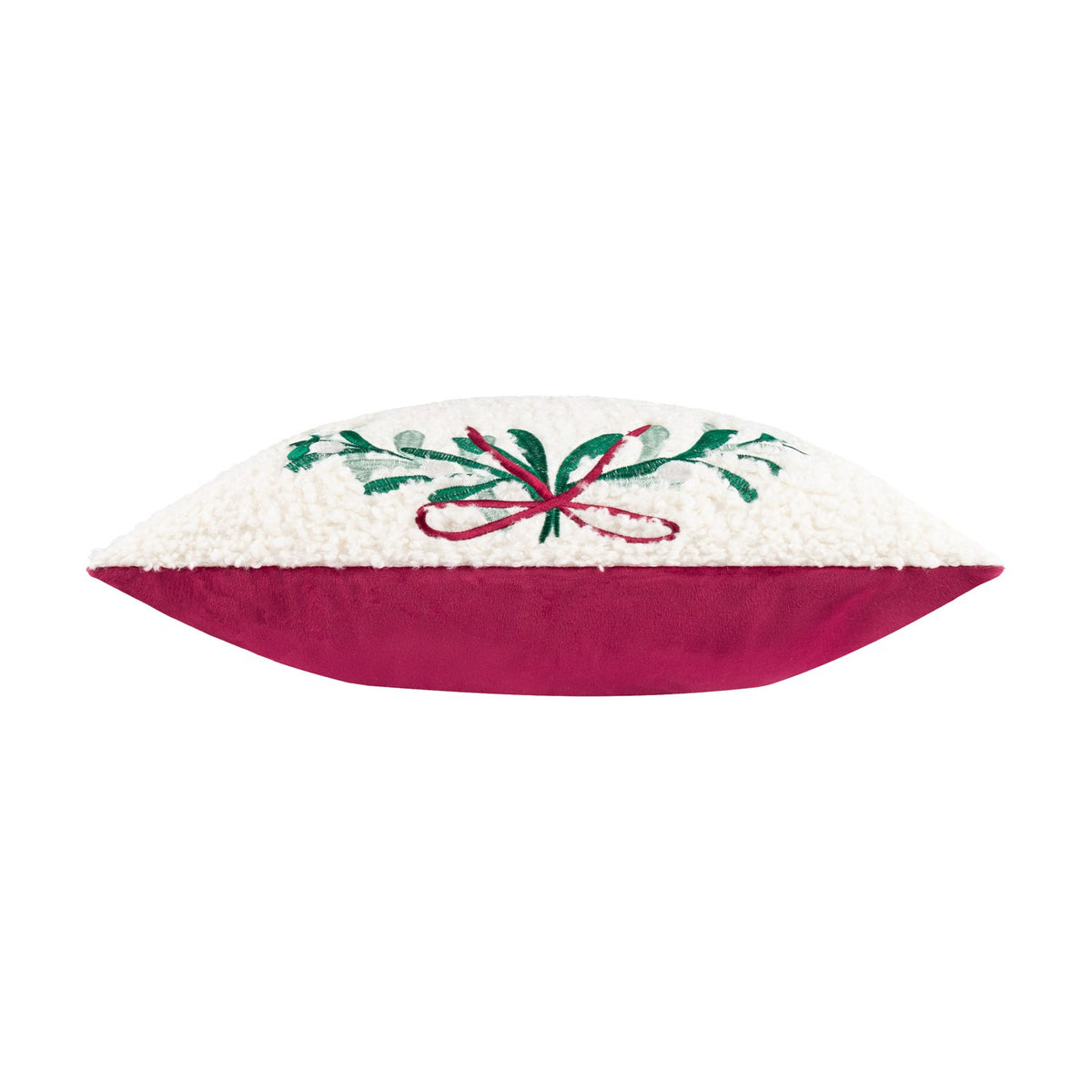 Side view of the Mistletoe Wreath Embroidered Velvet Cushion, showing cream boucle front with green sprigs and red ribbon embroidery against a pinky-red velvet reverse, on a white background.