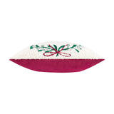 Side view of the Mistletoe Wreath Embroidered Velvet Cushion, showing cream boucle front with green sprigs and red ribbon embroidery against a pinky-red velvet reverse, on a white background.