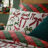 Nathalie Festive Bows Check Duvet Cover Set in Berry/Pine, showing the reversible bedding with a bow-print pillowcase and red-green tartan check duvet on a styled bed.