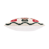 Side view of the Nutcracker Trio Tufted Cotton Cushion, showing its plump square shape with a tufted cream, red and green patterned edge and plain white reverse, set against a white background.