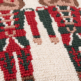 Close-up of the Nutcracker Trio Tufted Cotton Cushion, showing loop-tufted texture in red, green, cream and tan forming part of the nutcracker soldier design.