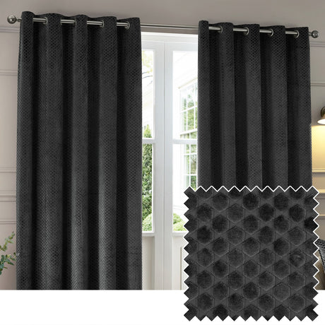 Neptune Velvet Fully Lined Eyelet Curtains in charcoal, shown as a pair on a metal pole with grommet header, styled beside a window, with a fabric swatch showing the raised honeycomb texture.