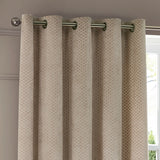 Neptune Velvet Fully Lined Eyelet Curtains in champagne, showing cut velvet fabric with a repeating geometric dot pattern and metal eyelet heading on a rod, hung in a living room.
