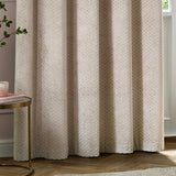 Neptune Velvet Fully Lined Eyelet Curtains in champagne, showing eyelet-header folds with a subtle dot-patterned cut velvet texture, styled in a living room with wood flooring.