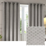 Neptune Velvet Fully Lined Eyelet Curtains in silver grey with a geometric cut-pile design, shown hanging beside a window, alongside a fabric swatch.