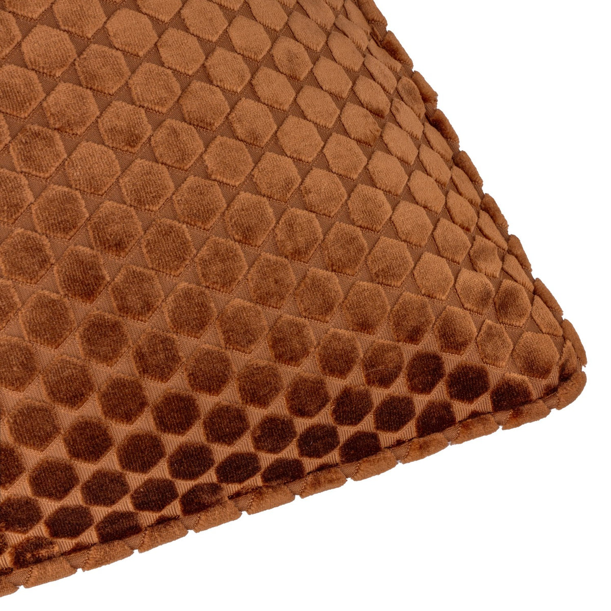 Close-up of the Neptune Geometric Velvet Cushion in copper, showing a raised honeycomb velvet pattern with piped edging on a plain white background.