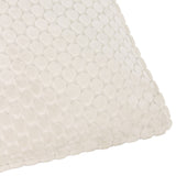 Close-up of the Neptune Geometric Velvet Cushion in ivory, showing raised honeycomb-style pattern and piped edge on a plain white background.